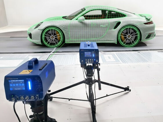 Vibration analysis of a sports car with laser vibrometers measuring vibrations visualized as a grid pattern on the car.